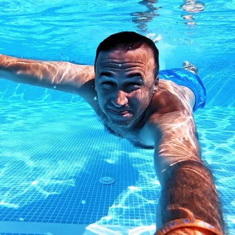 swimming underwater man in pool