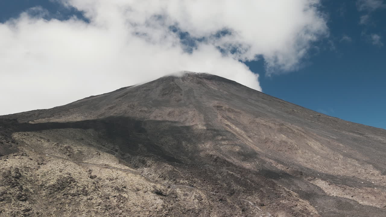 Volcanic Mountain Peak with Clouds