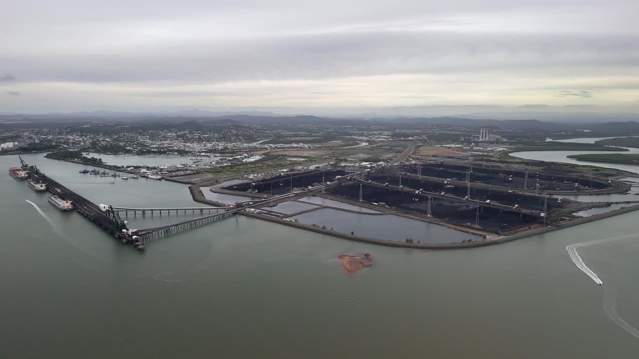 Overcast aerial approaches Gladstone coal terminal in QLD Australia