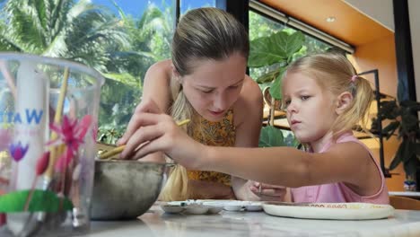 mother and daughter painting together