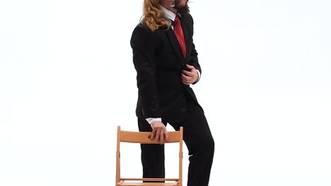 man in black suit and fedora hat posing in studio