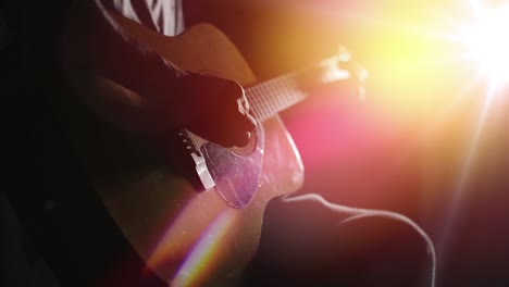 guitarist playing acoustic guitar. unplugged performance in the dark.