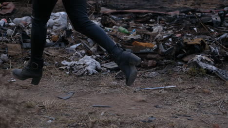 Close-up-of-two-girls-running-through-the-trash-at-a-dumpsite