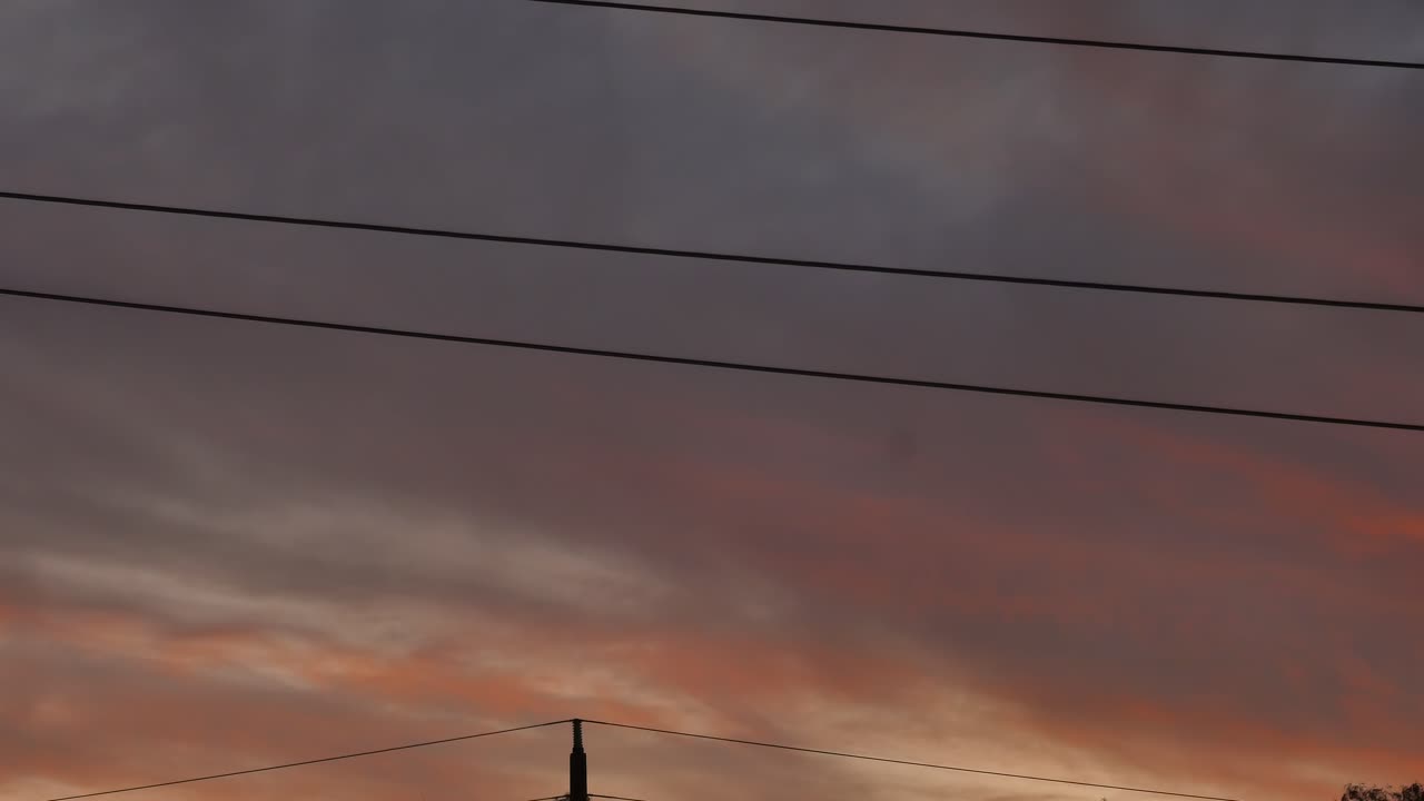 Sunset sky over power line cables