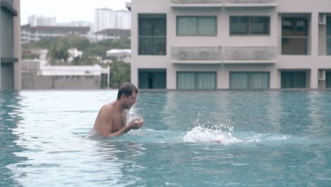 daddy and little girl play in hotel pool water slow motion