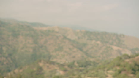 attractive italian caucasian woman tourist walking past camera, mountains in the background, savoca