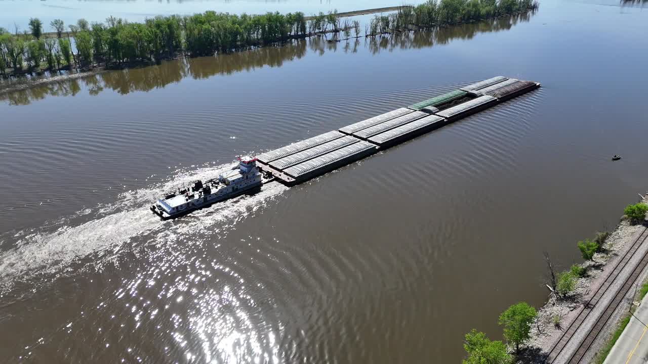 Located along the Mississippi River between Minnesota and Wisconsin's Driftless area, a towboat move a set of barges south.