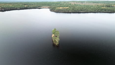 Üppige-Insel-In-Der-Mitte-Des-Sees-Mit-Schwarzem-Wasser-Und-Tannenwald-Im-Herbst-In-Schweden