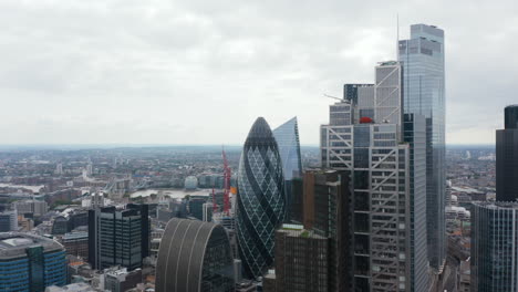 Stürmer-Fliegen-über-Die-Innenstadt.-Auf-Dem-Weg-Zu-Den-Wolkenkratzern-Der-Stadt.-Das-Ikonische-Runde-Gebäude-Mit-Verdrehtem-Muster-Sieht-Aus-Wie-Eine-Gurke.-London,-Vereinigtes-Königreich