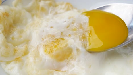 fried egg with spoon