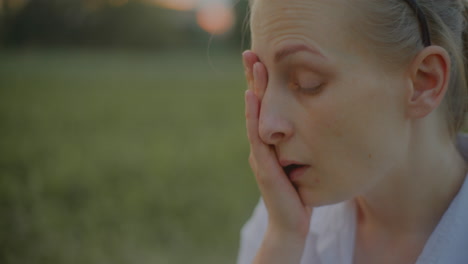 close-up of woman rubbing tired eyes