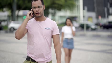 Front-view-of-handsome-young-man-talking-on-smartphone