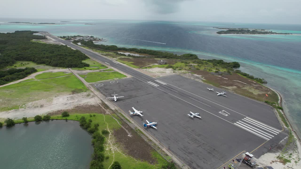 Aerial view of Los Roques airport, planes on runway, serene atmosphere