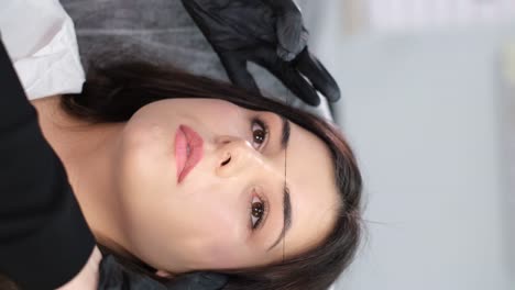 woman undergoing eyebrow mapping for cosmetic procedure