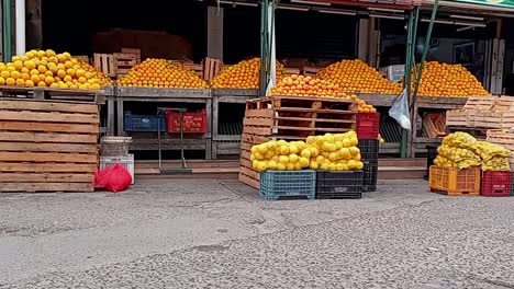 Slider-Shot-Of-Local-Fruits-Market,-Citrus-Displayed-In-Pyramids,-Paraguay