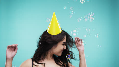 Crazy-face-Indian-woman-dancing-in-bubble-shower--slow-motion-photo-booth-blue-background