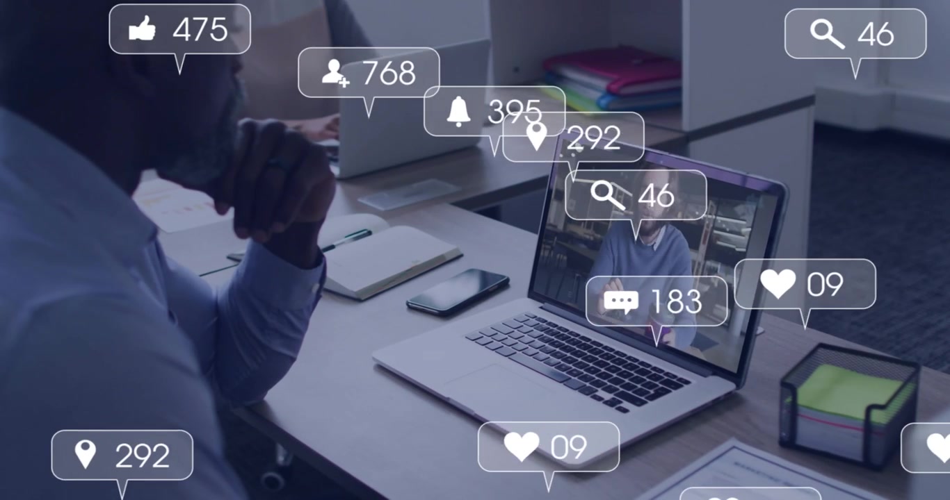 Businessman watching laptop presenter, generating rising engagement icons showing marketing metrics