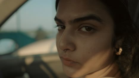 Intense-gaze,-close-up-of-a-young-Indian-woman-with-a-nose-pen---with-a-nose-piercing,-looking-sideways