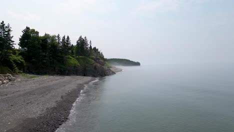 misty and foggy shoreline with coastal erosion and natural weathering forces