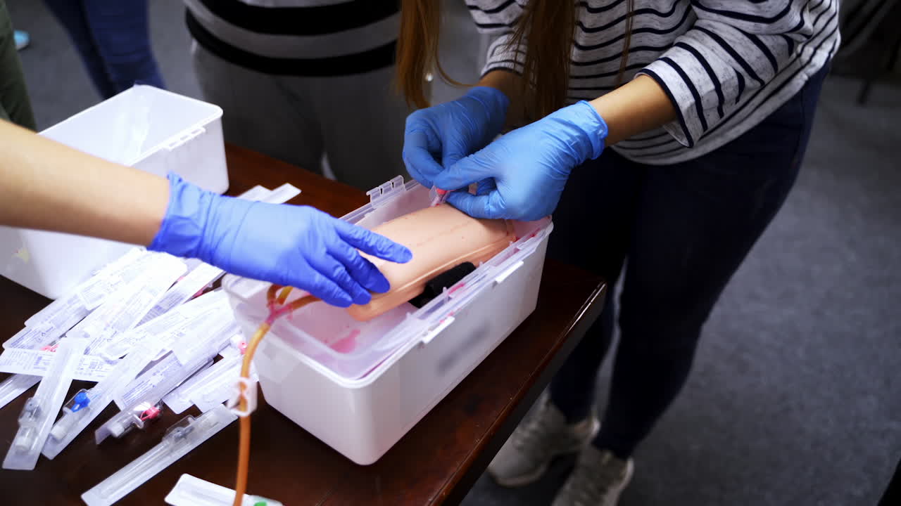 Doctor in gloves making injection with a syringe for puncture. Simulation medical training model. Medical procedure concept, simulation medicine training.