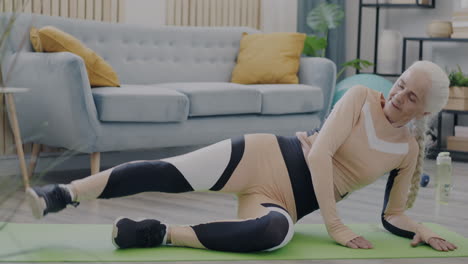 senior woman doing leg exercises at home
