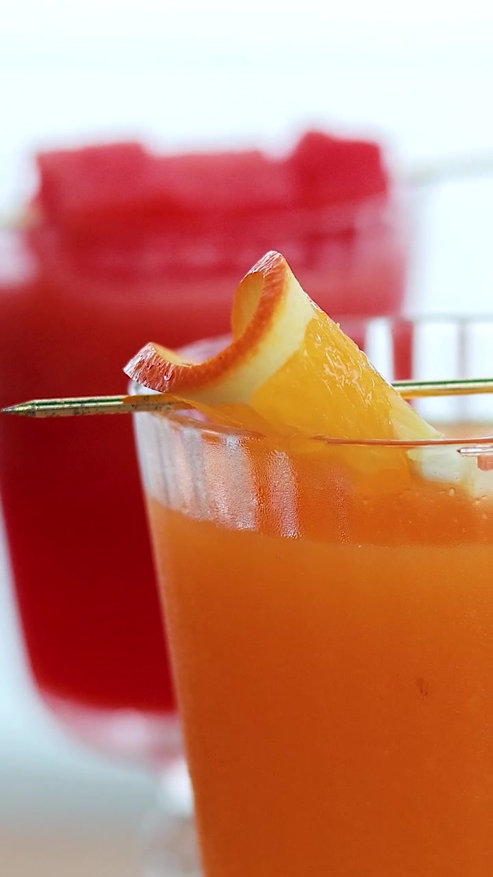 Orange and watermelon juices in tropical setting