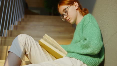 girl reading on stairs