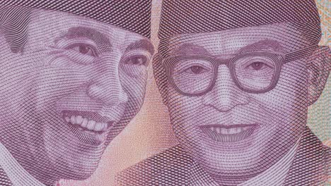 macro view of indonesian rupiah: soekarno and mohammad hatta on the 100,000 bill