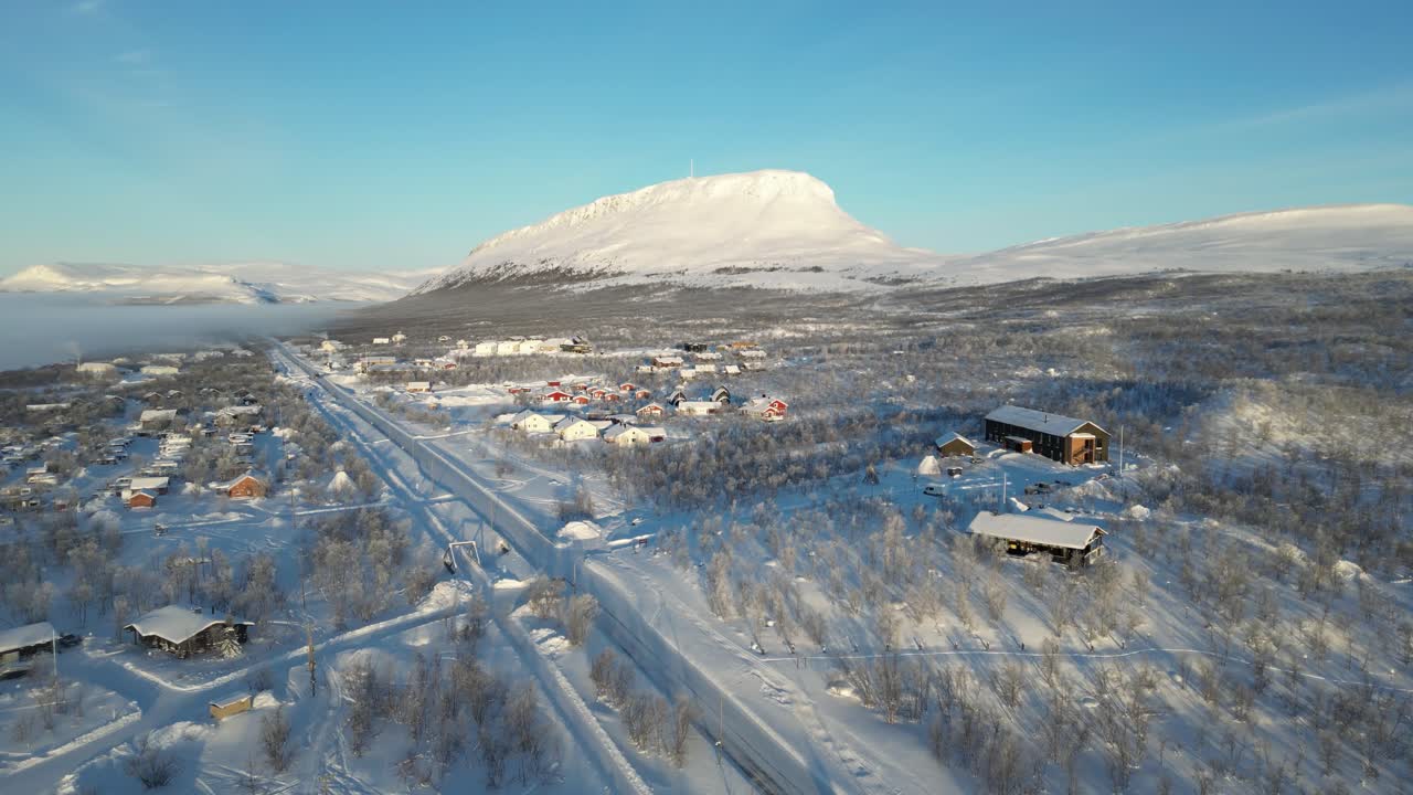 Kilpisjärvi town in the beautiful frosty and sunny winter morning. Moving drone footage