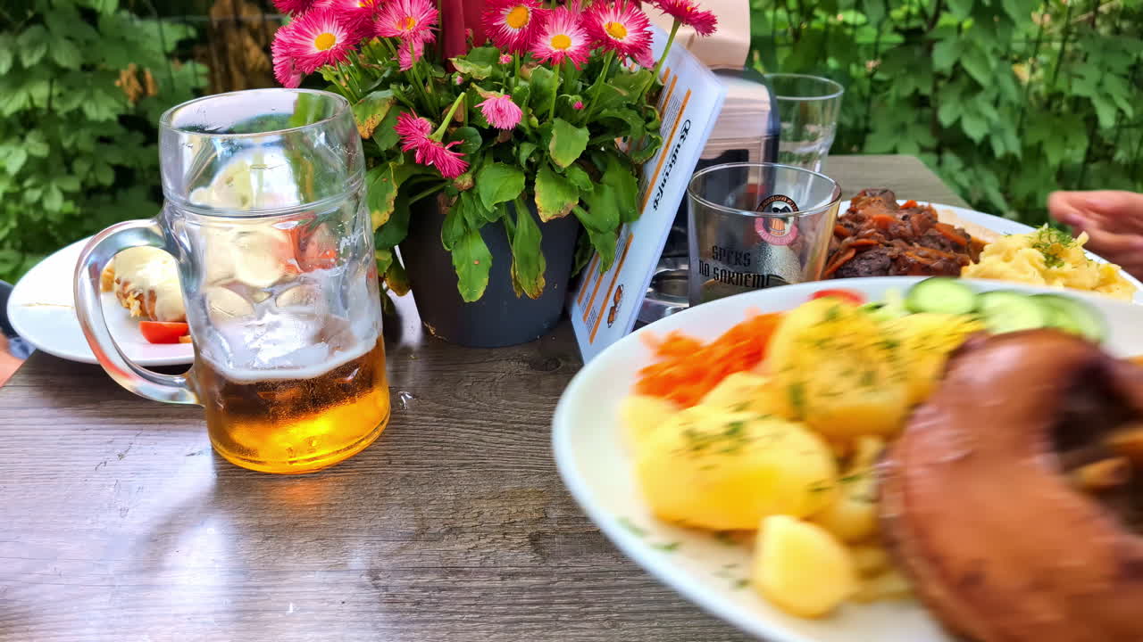 Serving a German dinner of pork, sauerkraut, potatoes, and beer