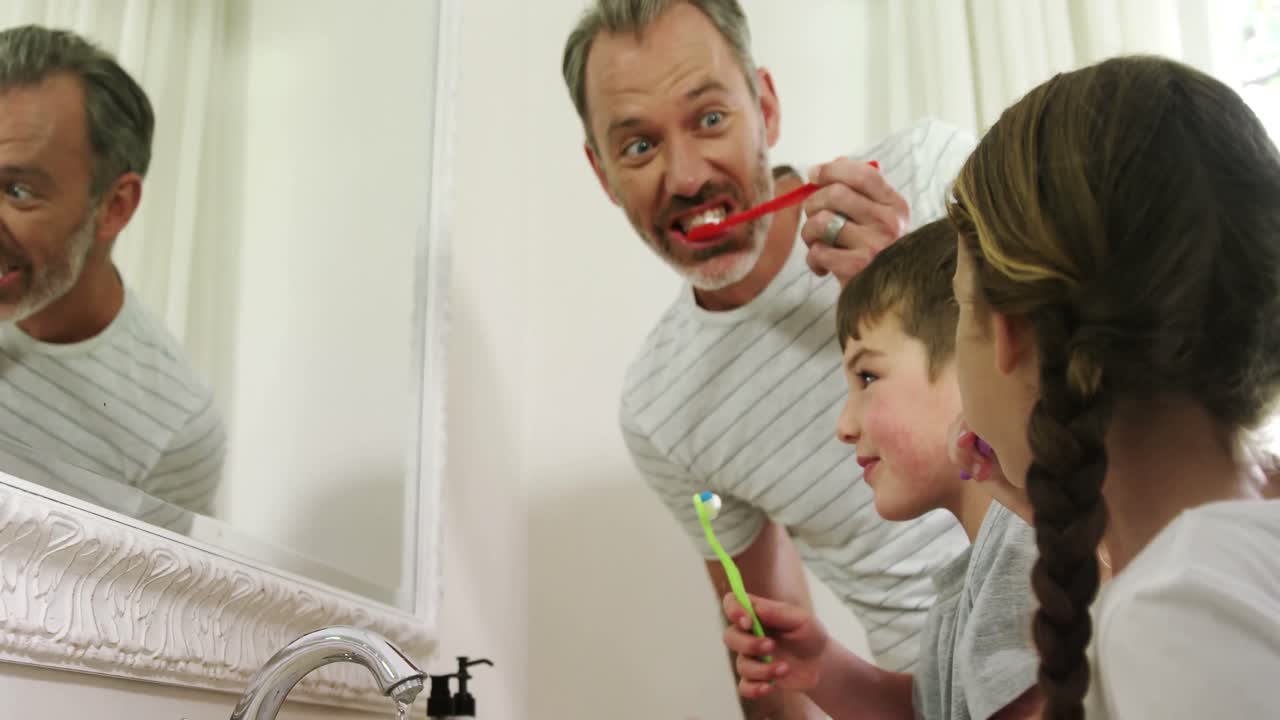 Family brushing their teeth in bathroom 4k