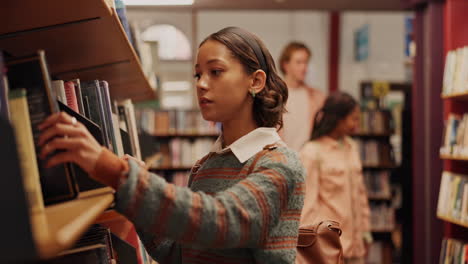 teenagers reading books in a library