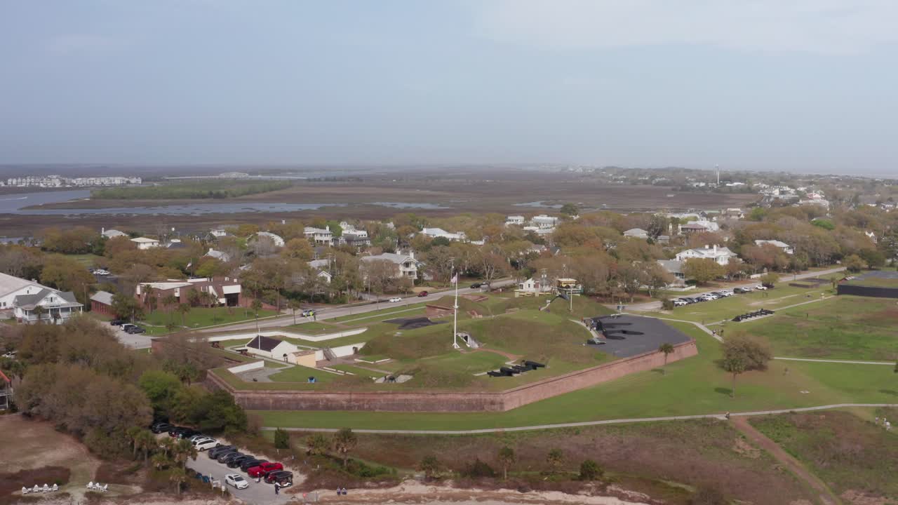 Wide reverse pullback shot of historic Fort Moultrie on Sullivan's Island in Charleston Harbor, South Carolina
