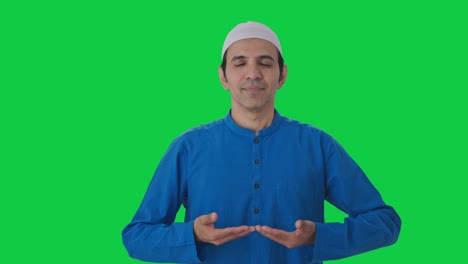 Concentrated-Muslim-man-doing-breathe-in-breathe-out-exercise-Green-screen