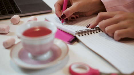 person writing on a notebook