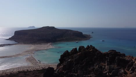 revealing aerial of balos island and lagoon over the cliff