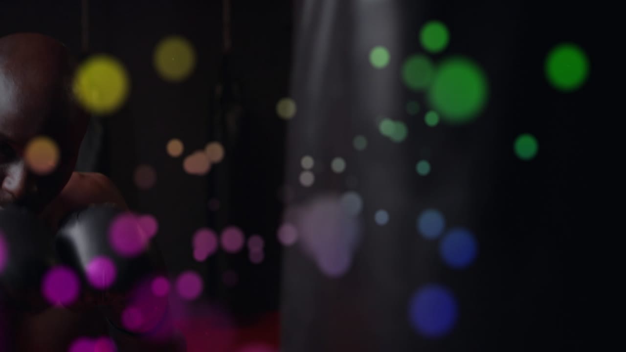 Male gloved boxer raising guard, stepping and throwing punches for boxing training under bokeh