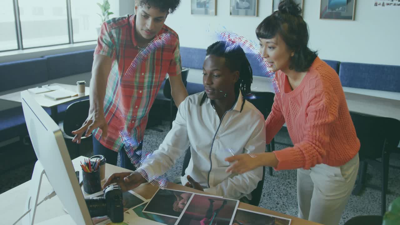 Emerging hologram globe above desk driving seated man tuning camera with tech team observing prints