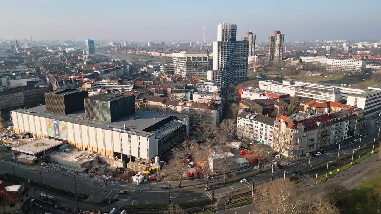 Drone flight over Mannheim towards the Collinicenter and Neckar River on a crisp, sunny winter day, capturing the city's skyline.