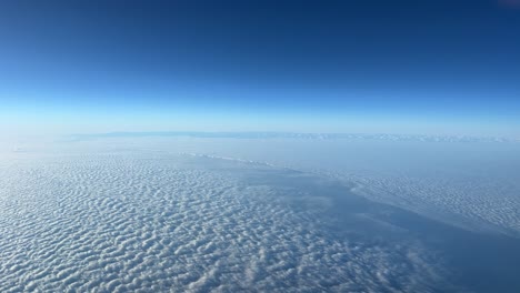 stunning aerial view: a pilot’s point of view while flying very high over a sea of clouds