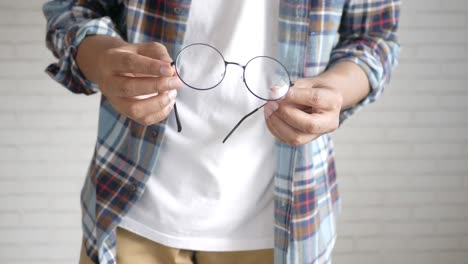 person cleaning glasses