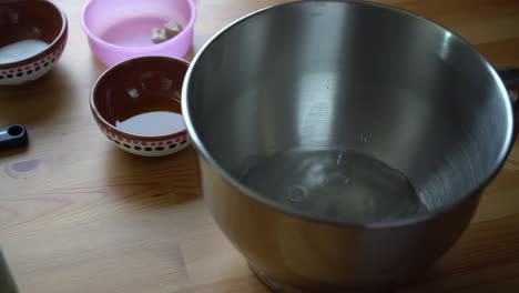 pouring water in a mixer bowl