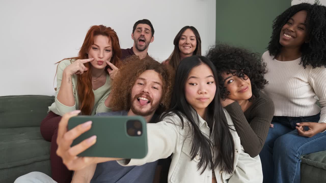 Multiethnic friends taking selfie on smartphone