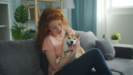 woman with shiba inu dog on a couch