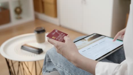 hands holding credit card and digital tablet with application booking flight travel search ticket holiday and hotel on website discounted price.