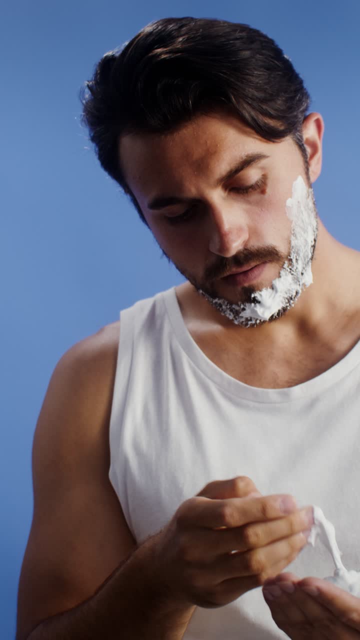 Man Applying Shaving Cream to Beard