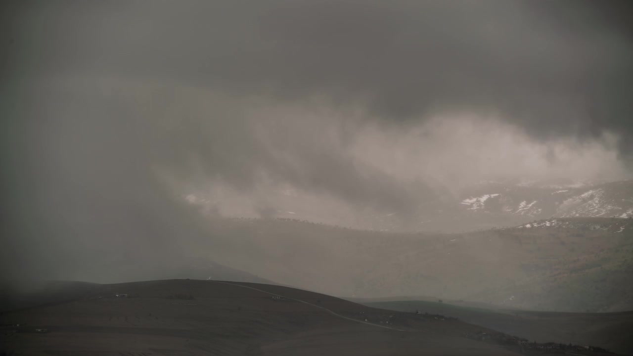 Stormy Clouds Moving Over Snowy Mountain Landscape