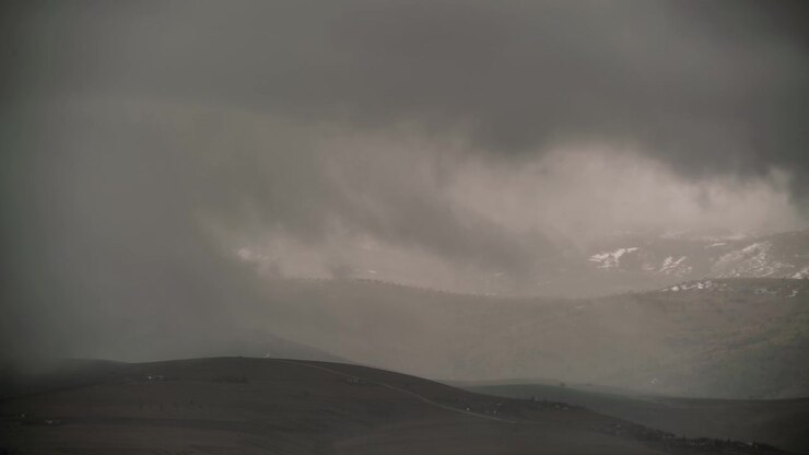 Stormy Clouds Moving Over Snowy Mountain Landscape