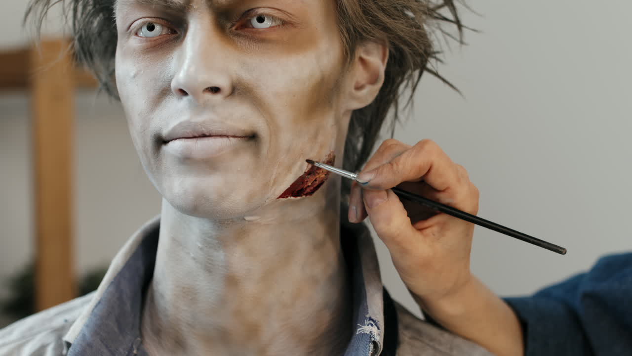 SFX Makeup Artist Making Fake Wound on Man