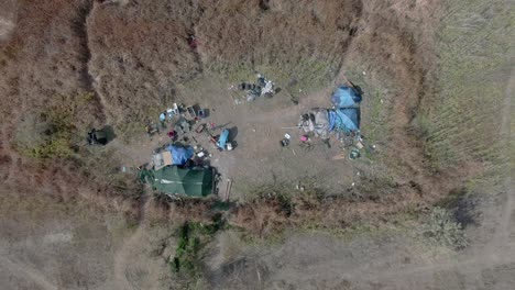 aerial view of homeless camp in the middle of a field